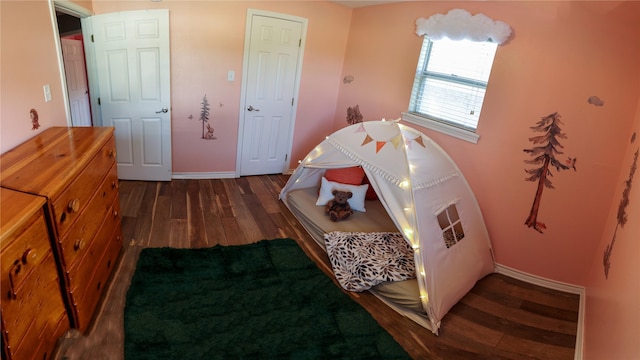 bedroom with wood finished floors and baseboards