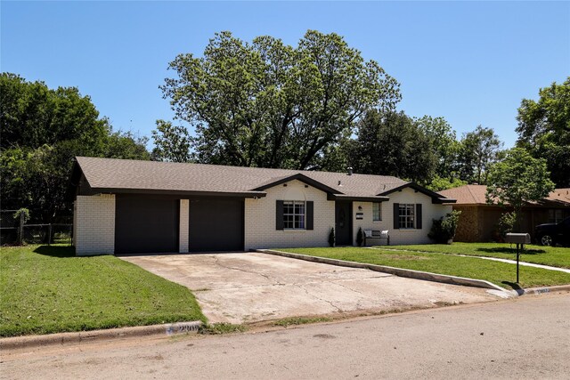 ranch-style house with brick siding, driveway, and a garage