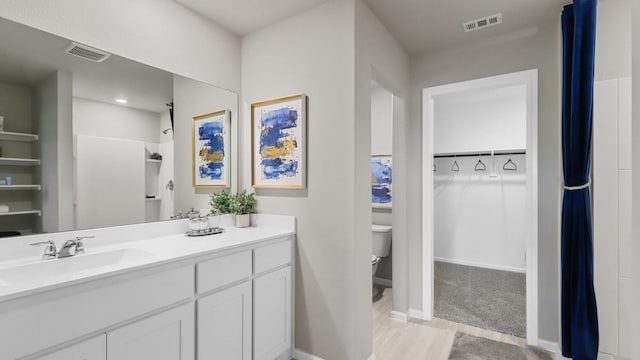 4109 Azam Ln, Fort Worth, TX 76036 - bathroom featuring toilet, a spacious closet, vanity, and baseboards
