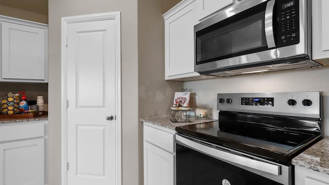 4109 Azam Ln, Fort Worth, TX 76036 - kitchen with stainless steel appliances, white cabinetry, and light stone counters