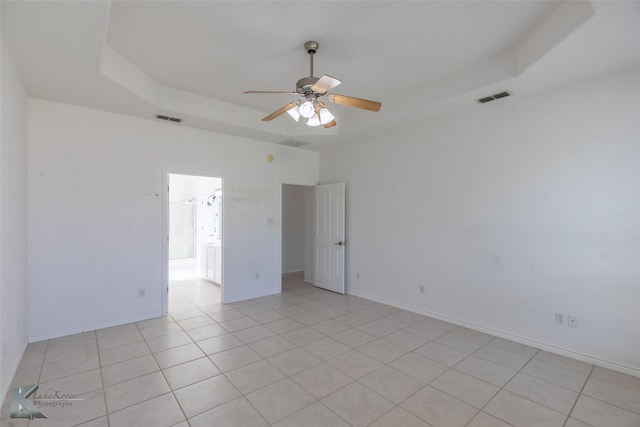 7118 Sable Cir, Abilene, TX 79606 - unfurnished room featuring a tray ceiling, a ceiling fan, light tile patterned floors, and baseboards