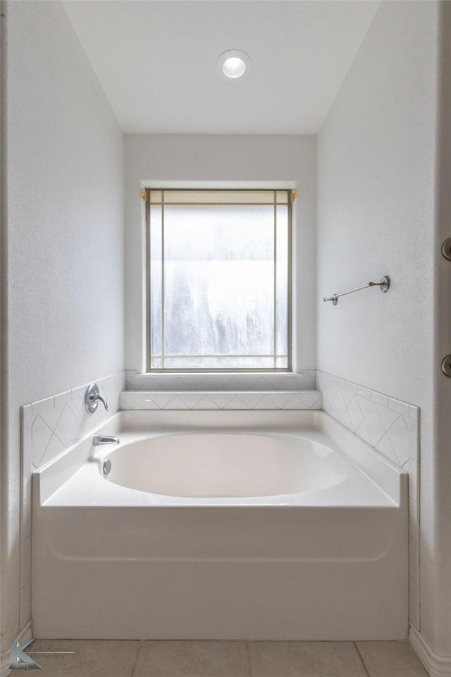 7118 Sable Cir, Abilene, TX 79606 - bathroom with healthy amount of natural light, tile patterned flooring, and a garden tub
