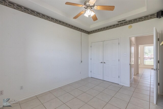 7118 Sable Cir, Abilene, TX 79606 - unfurnished bedroom featuring a closet, light tile patterned flooring, baseboards, and a ceiling fan
