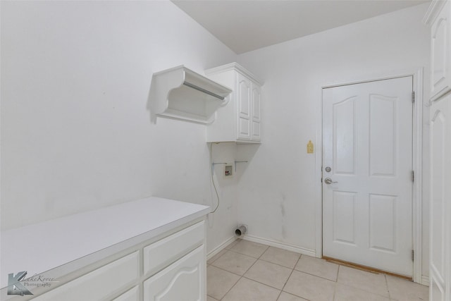 7118 Sable Cir, Abilene, TX 79606 - laundry room with cabinet space, light tile patterned floors, baseboards, and hookup for a washing machine