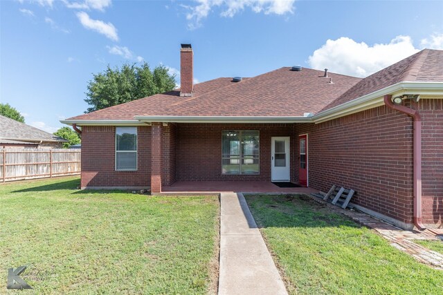 7118 Sable Cir, Abilene, TX 79606 - back of property featuring brick siding, a chimney, roof with shingles, and a patio area