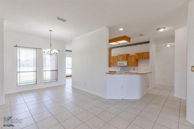 7118 Sable Cir, Abilene, TX 79606 - kitchen featuring white appliances, a chandelier, a peninsula, light tile patterned floors, and baseboards