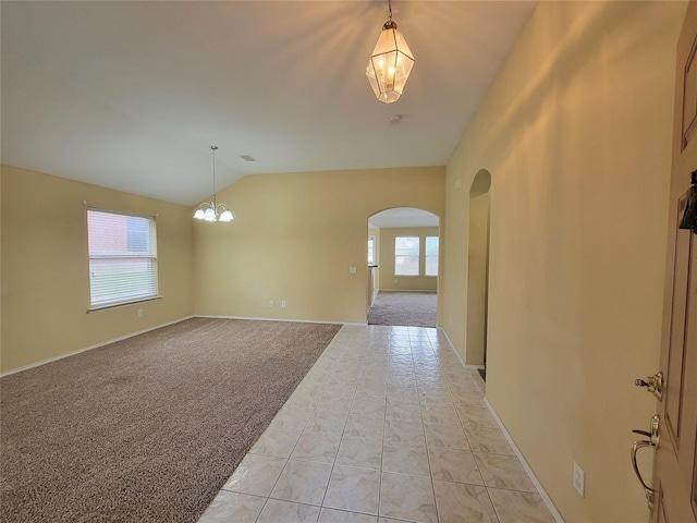 1006 Redwood Trl, Rockwall, TX 75087 - empty room with a chandelier, arched walkways, plenty of natural light, lofted ceiling, and light carpet