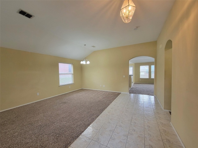 1006 Redwood Trl, Rockwall, TX 75087 - empty room with a chandelier, arched walkways, healthy amount of natural light, light carpet, and lofted ceiling