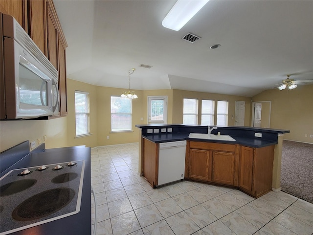 1006 Redwood Trl, Rockwall, TX 75087 - kitchen with white appliances, a sink, brown cabinets, a chandelier, and dark countertops
