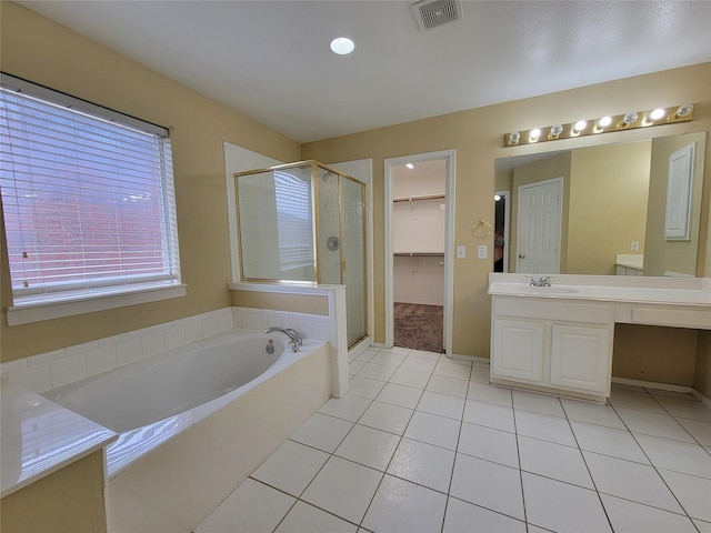 1006 Redwood Trl, Rockwall, TX 75087 - full bath featuring vanity, a stall shower, tile patterned floors, a garden tub, and a walk in closet