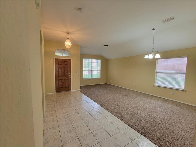 1006 Redwood Trl, Rockwall, TX 75087 - entrance foyer with lofted ceiling, light carpet, a chandelier, baseboards, and light tile patterned floors