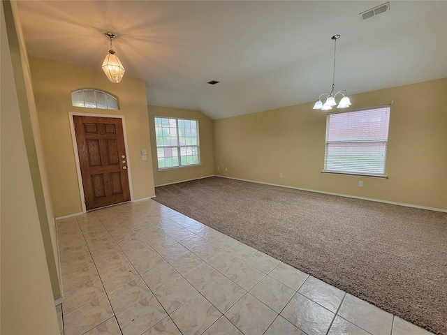 1006 Redwood Trl, Rockwall, TX 75087 - foyer featuring light carpet, lofted ceiling, a chandelier, baseboards, and light tile patterned flooring