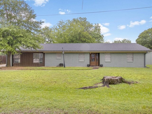 single story home featuring a front yard, cooling unit, and brick siding
