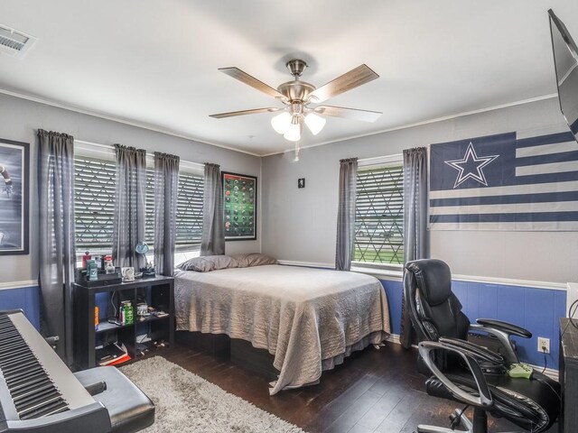 bedroom with hardwood / wood-style flooring, a desk, crown molding, and a ceiling fan