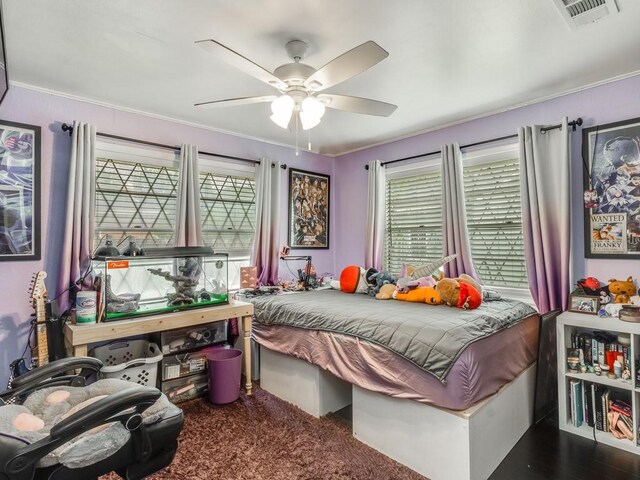 bedroom with ceiling fan and ornamental molding