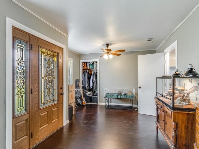 entryway with ornamental molding, wood finished floors, a ceiling fan, healthy amount of natural light, and baseboards