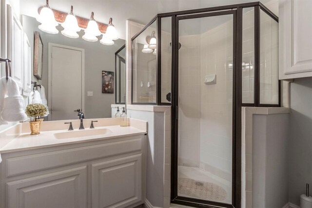 full bathroom with a shower stall and vanity