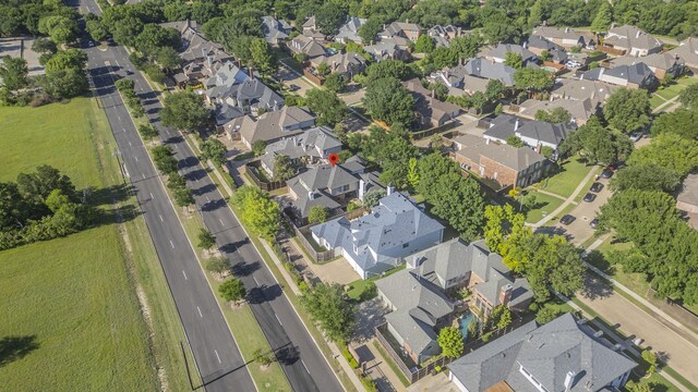 aerial view of property and surrounding area featuring nearby suburban area