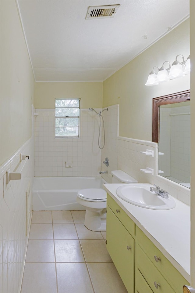 1809 Stevens St, Bridgeport, TX 76426 - bathroom with tile walls, shower / bath combination, toilet, vanity, and tile patterned flooring
