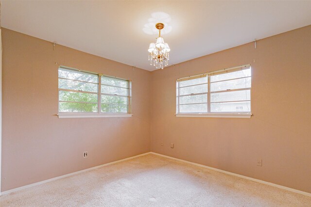 1809 Stevens St, Bridgeport, TX 76426 - spare room with a chandelier, baseboards, and carpet flooring