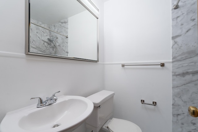 bathroom with a sink, toilet, and a shower