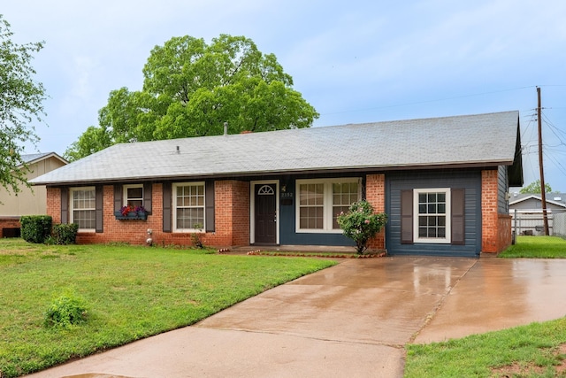 single story home featuring brick siding, driveway, and central AC