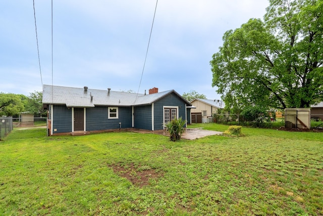 rear view of property featuring a patio and a chimney