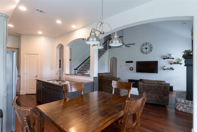 2974 Sparks Dr, Frisco, TX 75036 - dining space featuring a ceiling fan, dark wood-style floors, stairs, arched walkways, and recessed lighting
