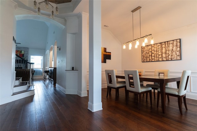 2974 Sparks Dr, Frisco, TX 75036 - dining room featuring arched walkways, stairs, dark wood-type flooring, vaulted ceiling, and baseboards