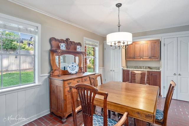 6030 Arden St, Shreveport, LA 71106 - dining space with brick flooring, ornamental molding, a chandelier, and a wainscoted wall