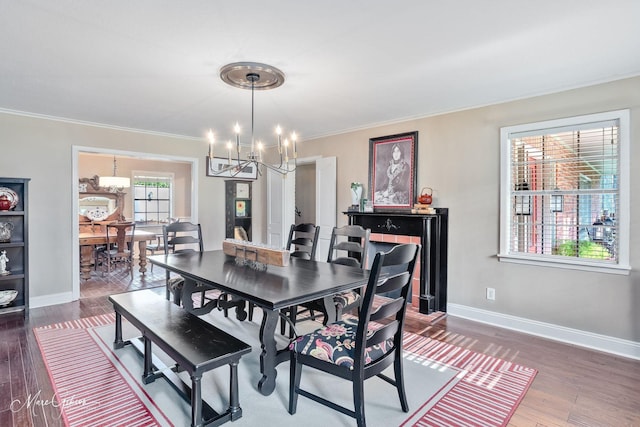 6030 Arden St, Shreveport, LA 71106 - dining room with a chandelier, crown molding, wood finished floors, and baseboards