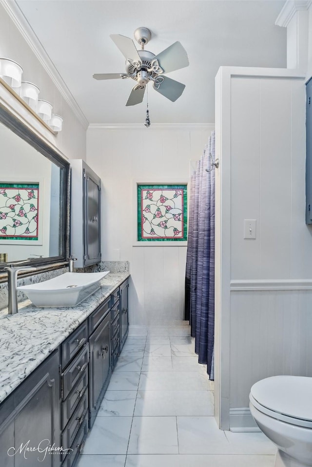 6030 Arden St, Shreveport, LA 71106 - bathroom featuring vanity, ceiling fan, toilet, marble finish flooring, and ornamental molding
