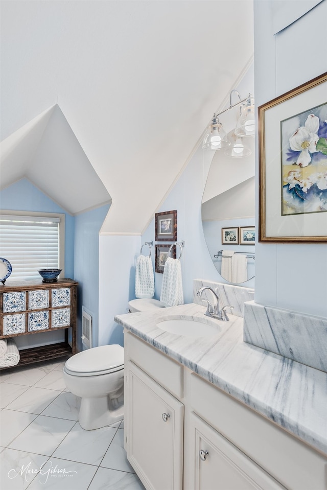 6030 Arden St, Shreveport, LA 71106 - bathroom featuring lofted ceiling, vanity, marble finish floors, and toilet