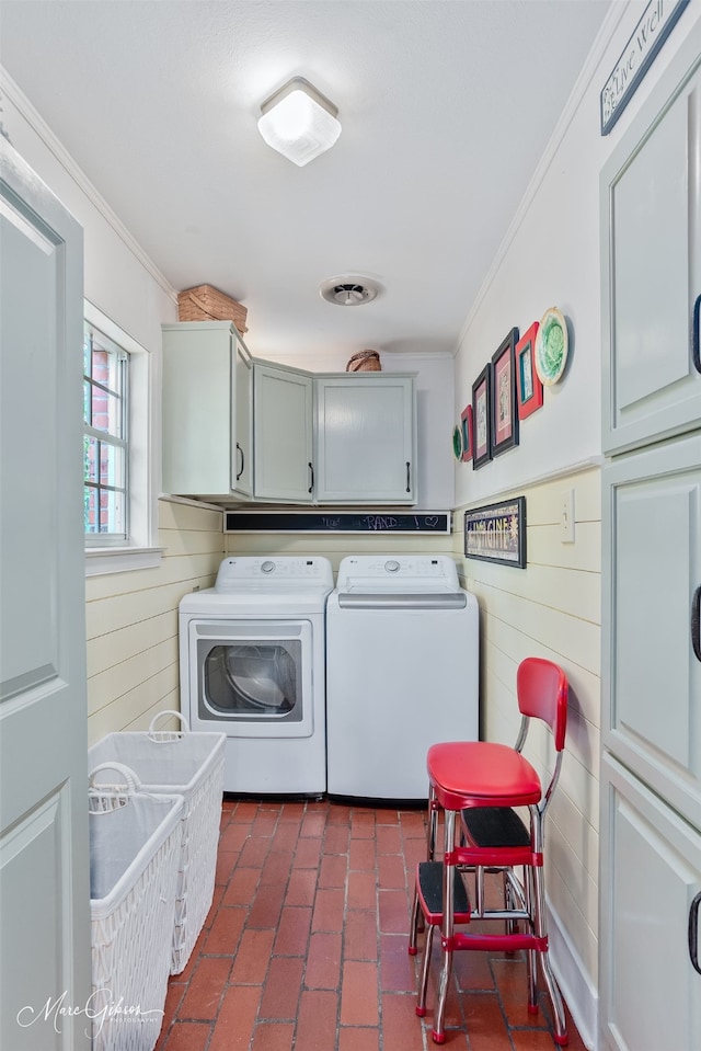 6030 Arden St, Shreveport, LA 71106 - laundry room with washing machine and dryer, cabinet space, ornamental molding, brick floors, and wooden walls