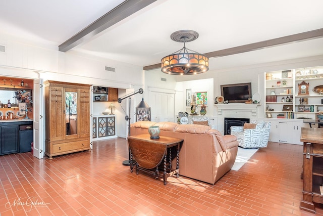 6030 Arden St, Shreveport, LA 71106 - living room featuring brick patterned flooring, a fireplace, and beamed ceiling