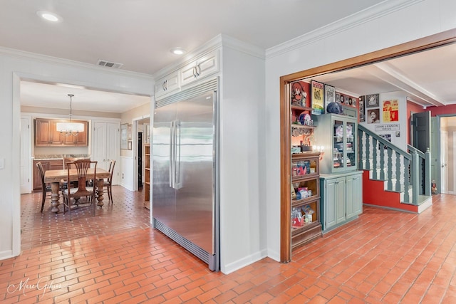 6030 Arden St, Shreveport, LA 71106 - kitchen with built in fridge, brick flooring, baseboards, a chandelier, and recessed lighting