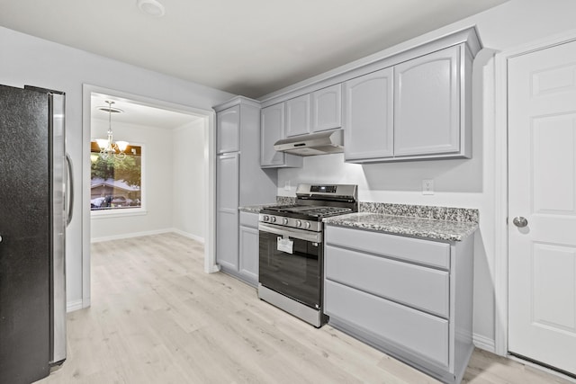 2909 Conejos Dr, Fort Worth, TX 76116 - kitchen with appliances with stainless steel finishes, gray cabinets, under cabinet range hood, and light wood finished floors