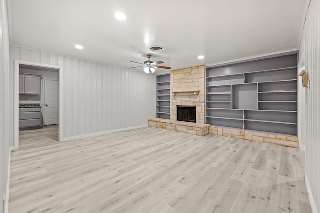 2909 Conejos Dr, Fort Worth, TX 76116 - unfurnished living room with a ceiling fan, wood finished floors, a fireplace, built in shelves, and baseboards