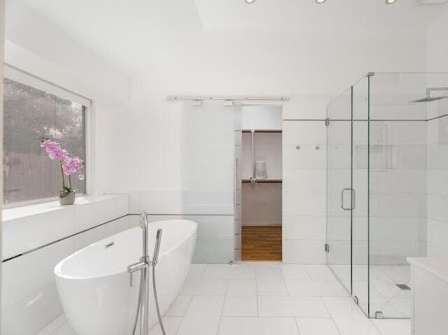 bathroom featuring a stall shower, a freestanding tub, and tile patterned floors
