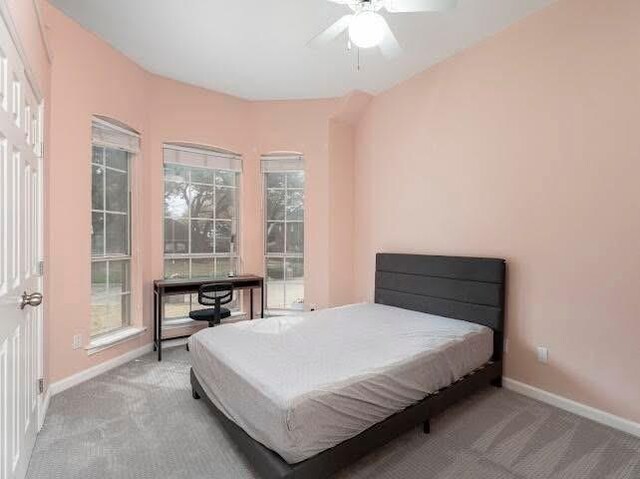 bedroom with carpet flooring, baseboards, and a ceiling fan