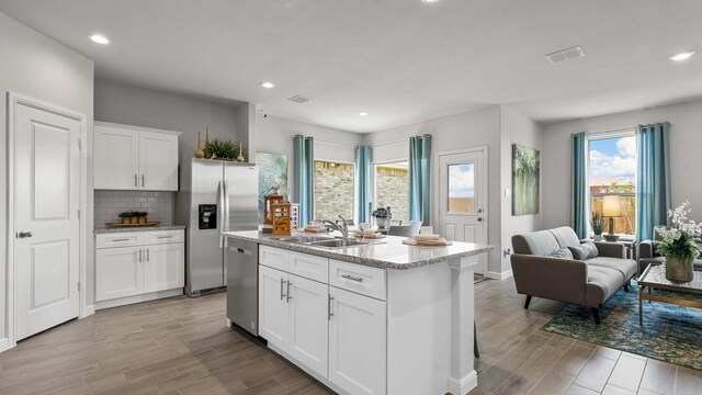 160 Trinity St, Grandview, TX 76050 - kitchen with a sink, appliances with stainless steel finishes, wood finish floors, open floor plan, and recessed lighting