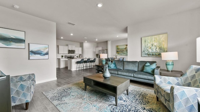 164 Trinity St, Grandview, TX 76050 - living area with wood tiled floors, recessed lighting, and baseboards