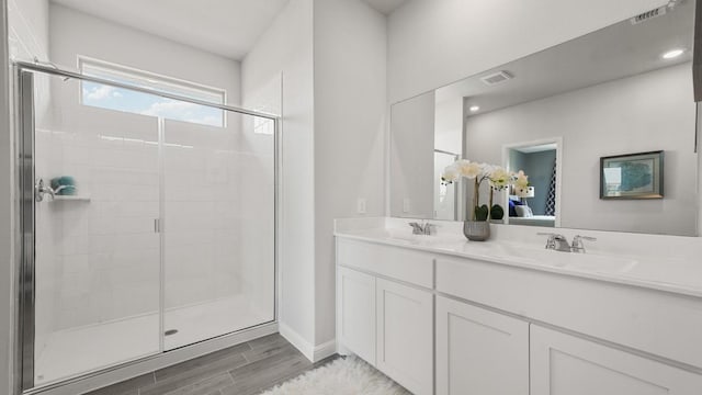 164 Trinity St, Grandview, TX 76050 - ensuite bathroom with a shower stall, wood finished floors, double vanity, and baseboards