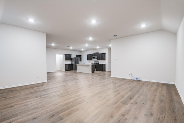 222 Redbarn Ln, Caddo Mills, TX 75135 - unfurnished living room featuring recessed lighting, baseboards, and light wood-style floors