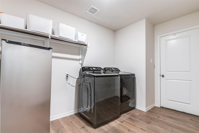 222 Redbarn Ln, Caddo Mills, TX 75135 - laundry room with separate washer and dryer, light wood-style flooring, and baseboards