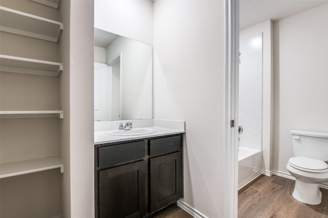 222 Redbarn Ln, Caddo Mills, TX 75135 - bathroom with wood finished floors, toilet, vanity, and baseboards