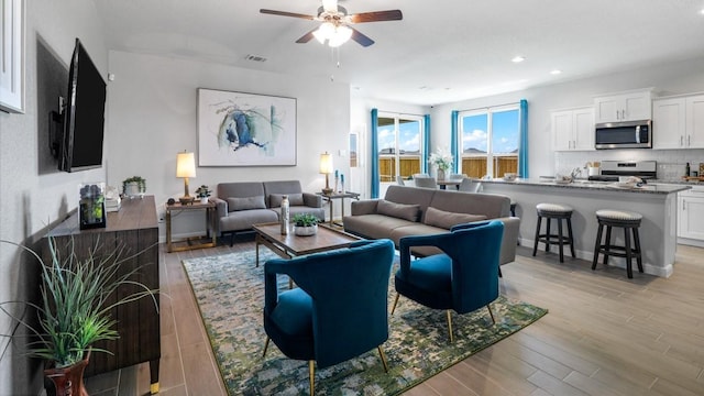 212 Trinity St, Grandview, TX 76050 - living area with light wood-style floors, ceiling fan, and recessed lighting
