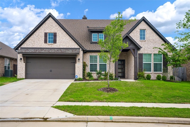 3224 Greymoore Dr, Anna, TX 75409 - craftsman-style home with brick siding, a shingled roof, cooling unit, a front yard, and concrete driveway