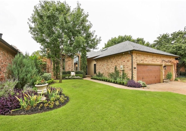 view of green lawn with a garage and concrete driveway