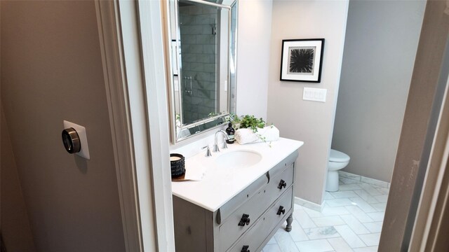 full bathroom with vanity, toilet, and tiled shower